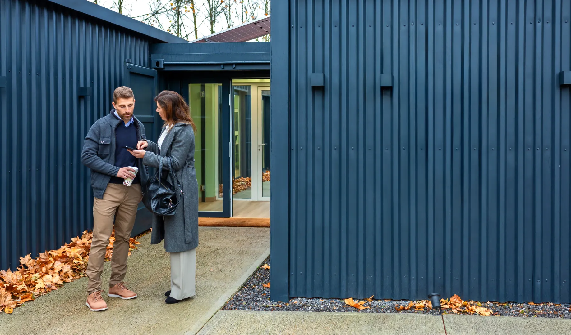 Modern house exterior with dark blue vertical steel siding