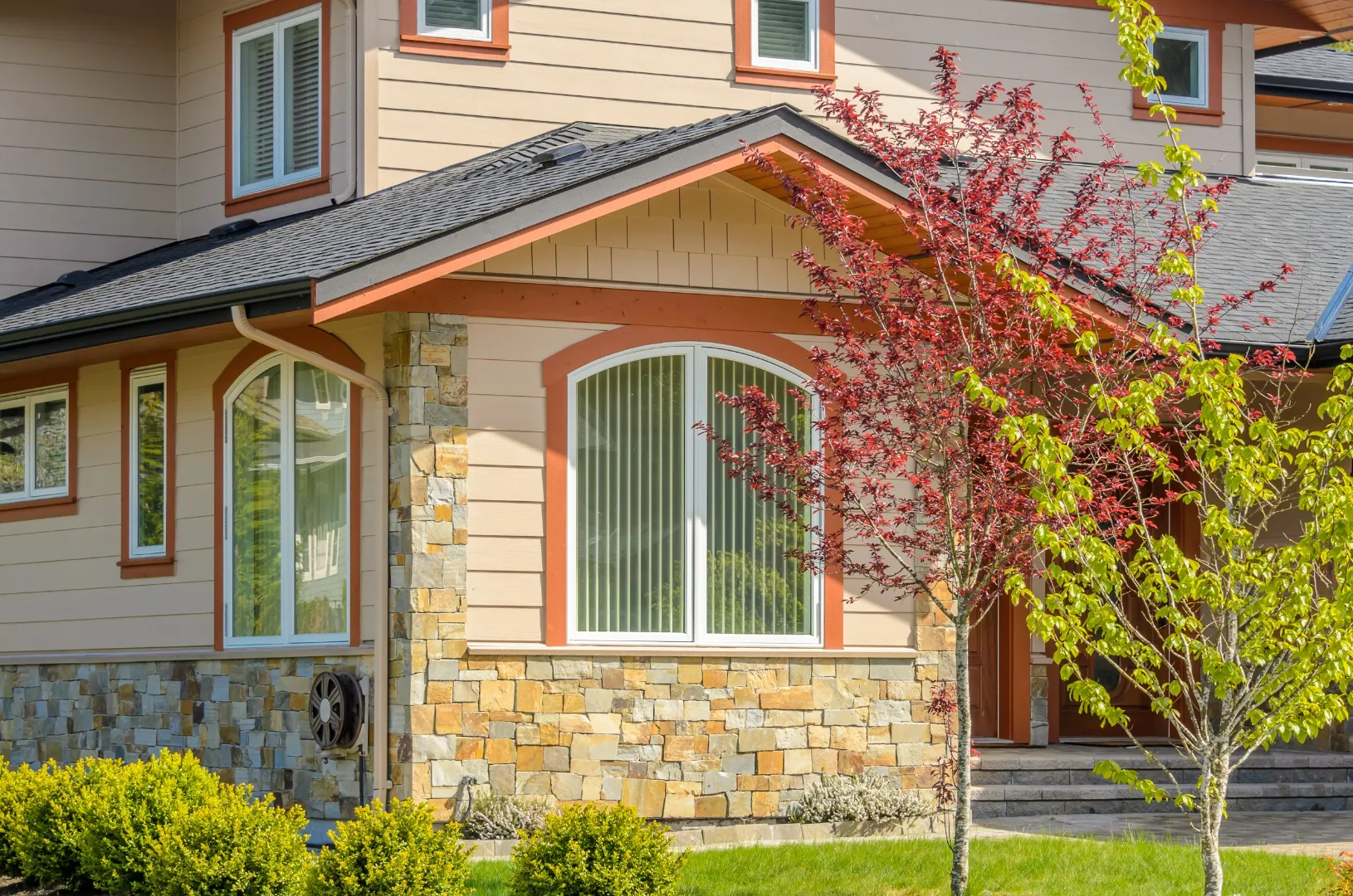 Modern home exterior with updated siding and landscaping improving curb appeal