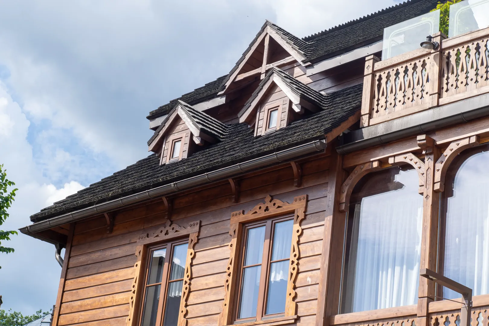 Traditional home exterior with natural wood siding and detailed architectural trim