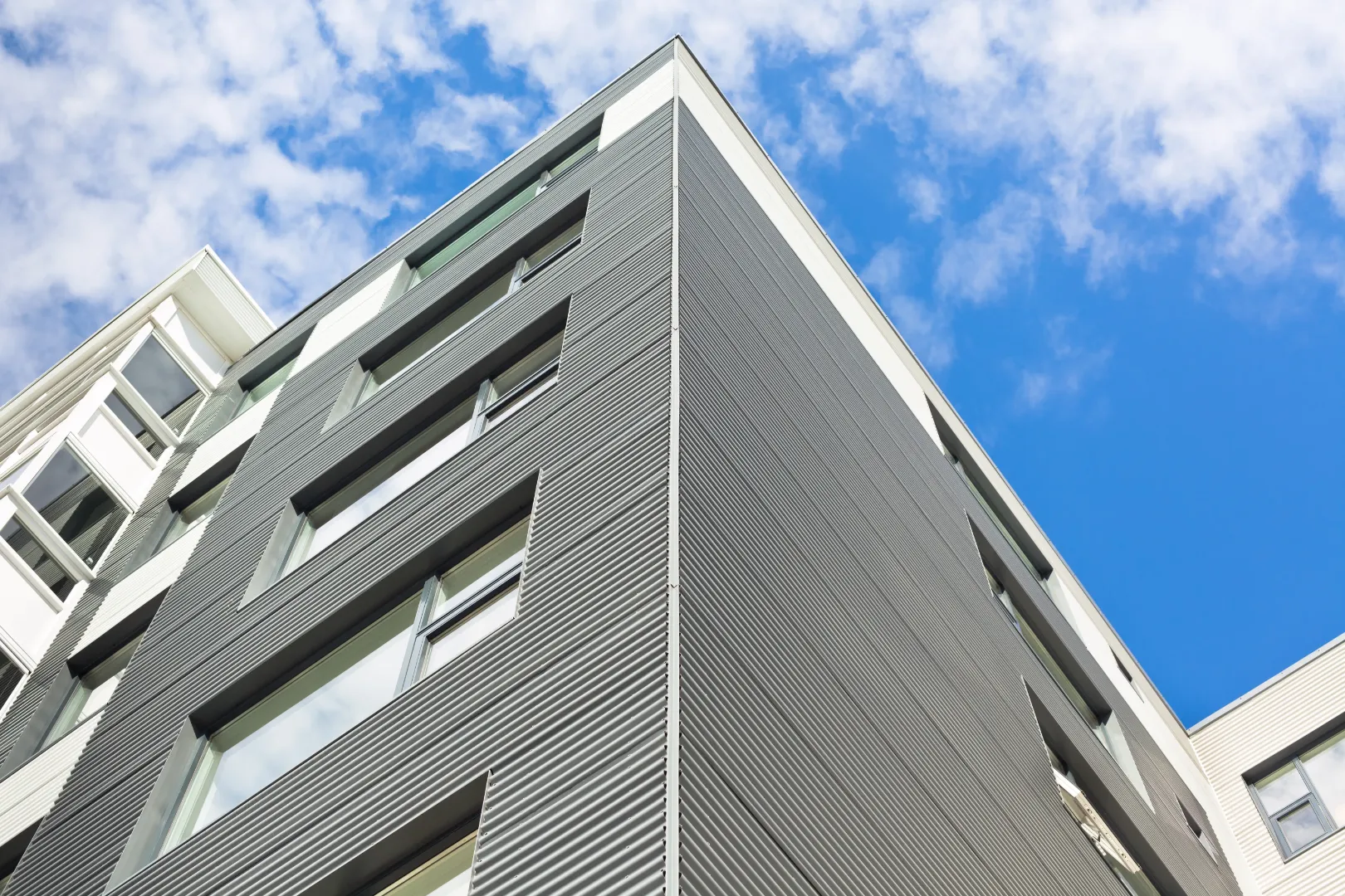 Modern residential building featuring sleek metal siding as a durable wood-look siding alternative.