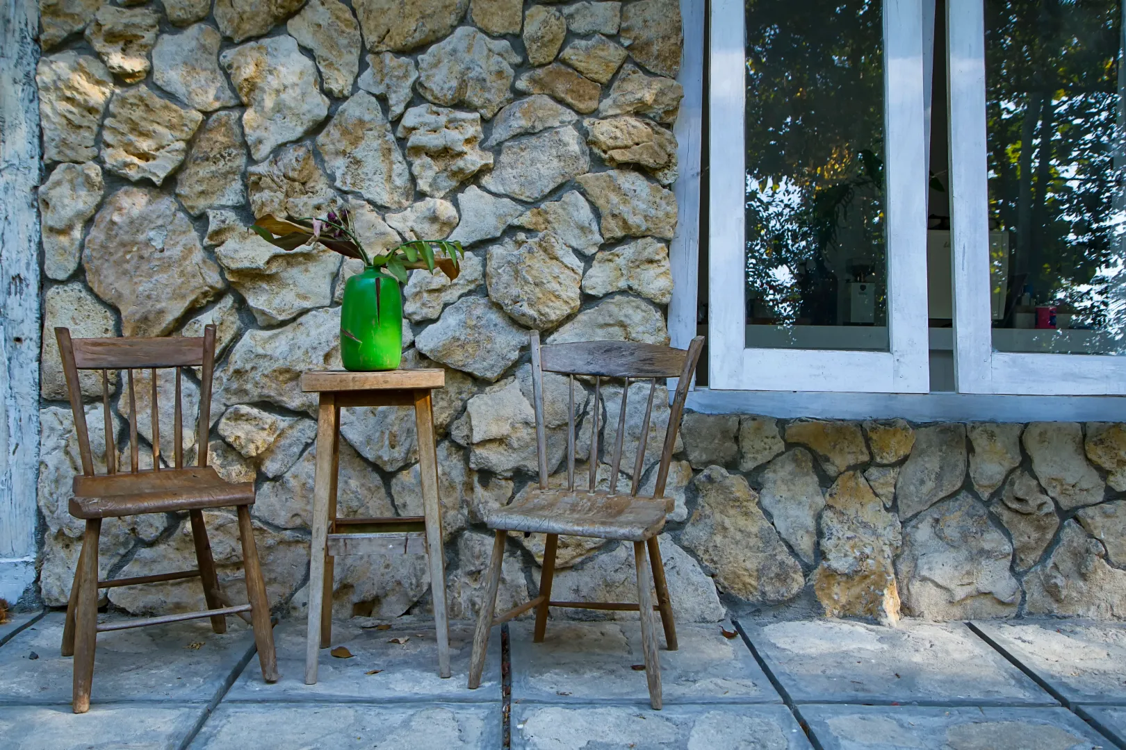 Stone veneer siding on a house exterior with a natural stone appearance