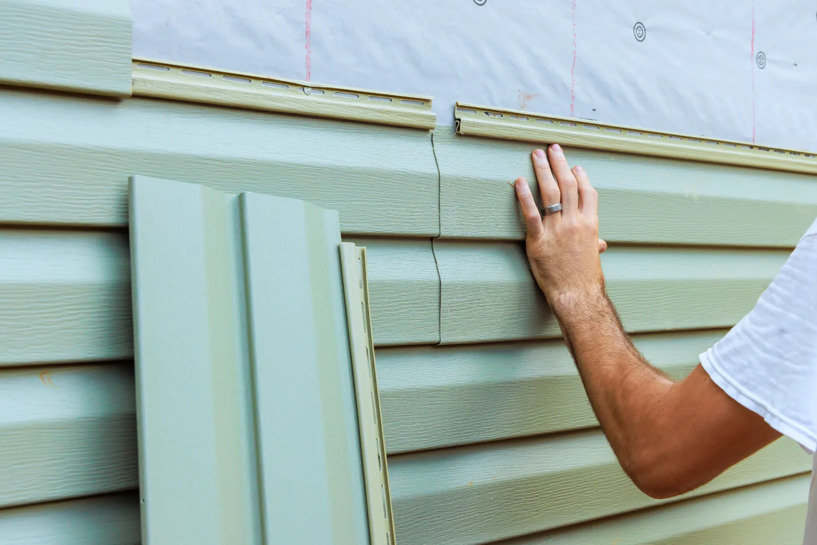 Vinyl siding being installed on a house exterior